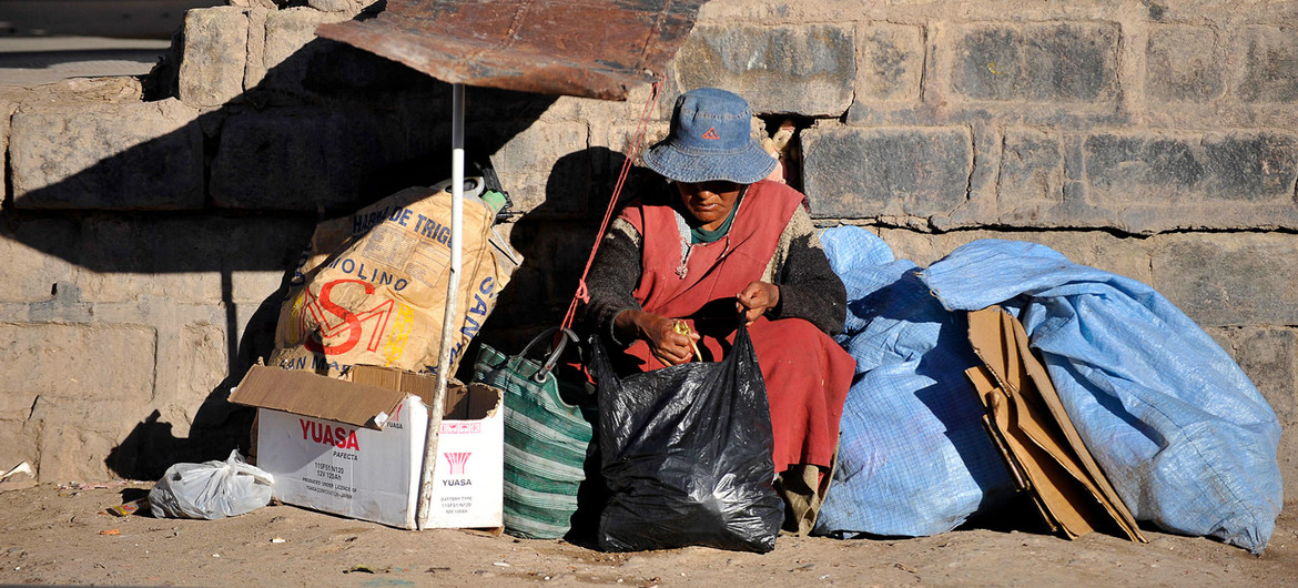A homeless woman sits by a railway track in Potosí, Bolivia.