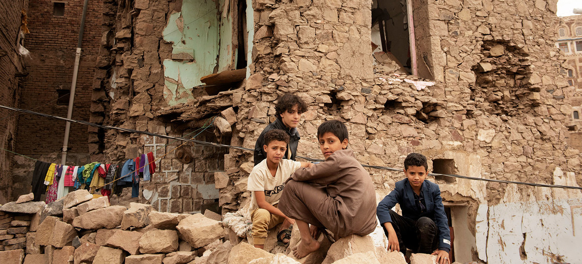 Children sit in front of a house damaged by an air strike, inside the old city of Sana'a, Yemen. (file)