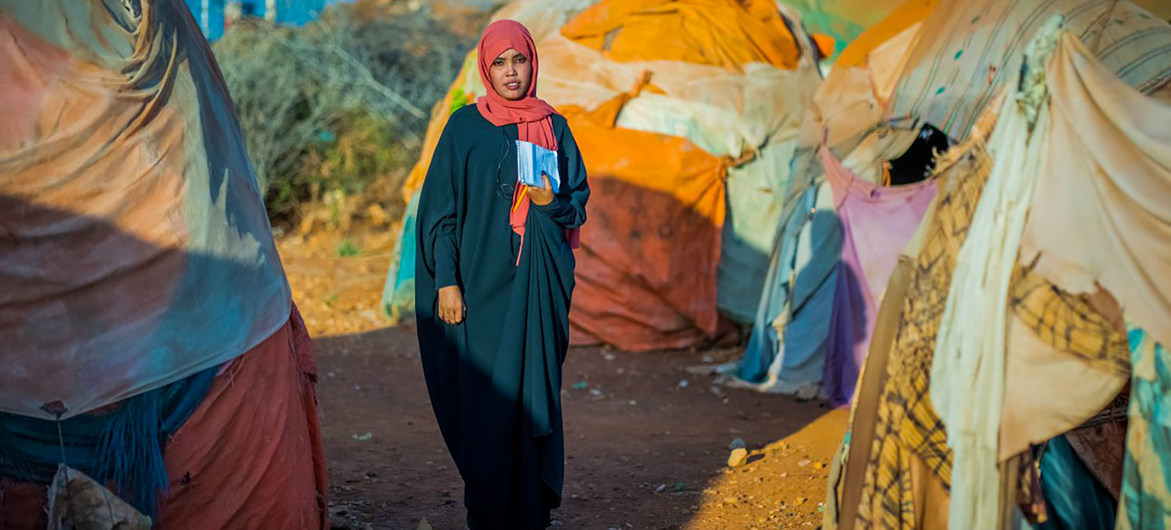 A case worker at a camp for internally displaced people in Somalia helps abused women get medical care.