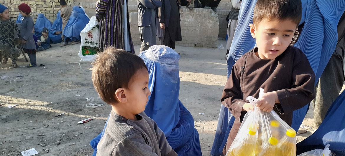 Families receive food and oil distributed by WFP in Faryab province, Afghanistan.