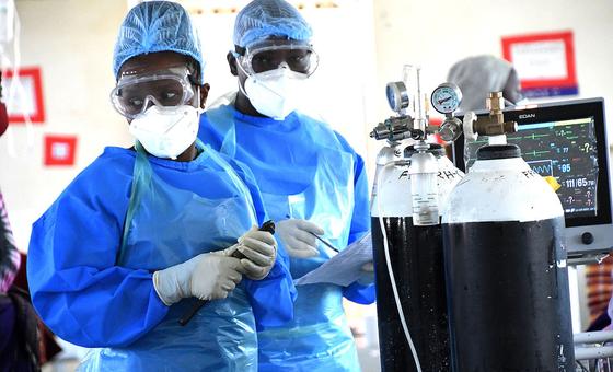 Doctors prepare oxygen cylinders for use in a COVID-19 ward at a hospital in Uganda.