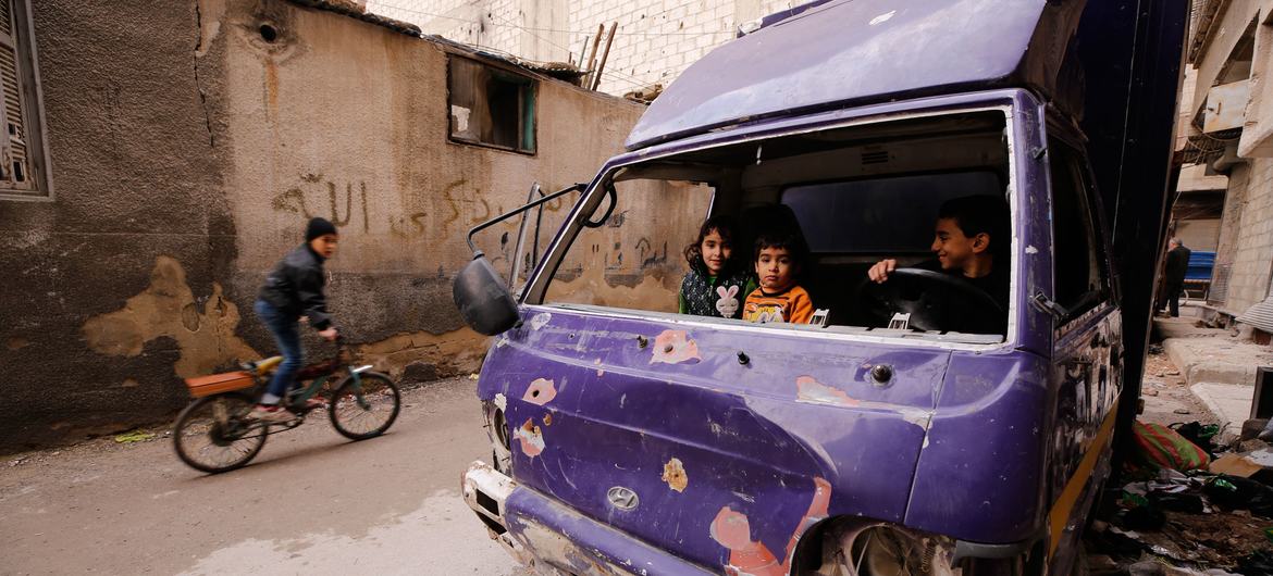 Children play in a damaged truck in Douma, Syria.