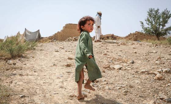 A boy walks up the hill to his former home, destroyed by the earthquake that hit Afghanistan in June 2022 .