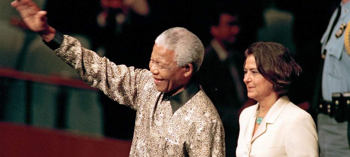 Nelson Mandela (left), President of South Africa, enters the General Assembly Hall to address its fifty-third session. At his side is United Nations Chief of Protocol, Nadia Younes, 21 September 1998