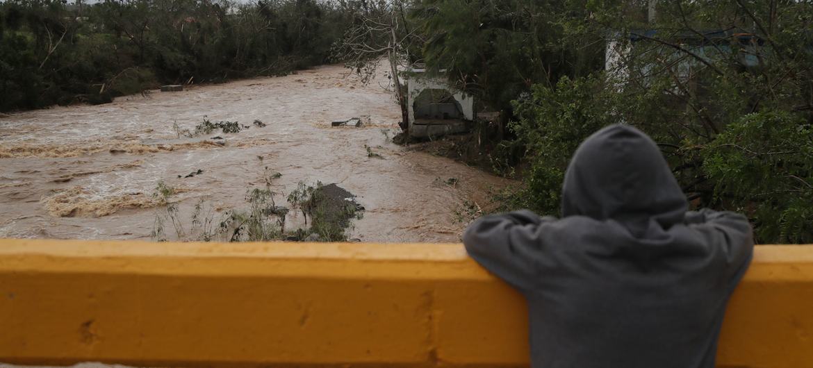 A boy stands on a bridge over the Sanate river in Higuey, one of the provinces most affected when Hurricane Fiona made landfall in the Dominican Republic.