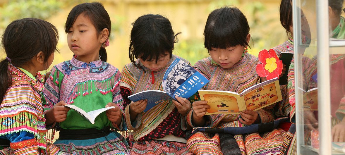 Girls from an indigenous community read outdoors at Ban Pho Primary School in Bac Han District in remote Lao Cai Province, Viet Nam.