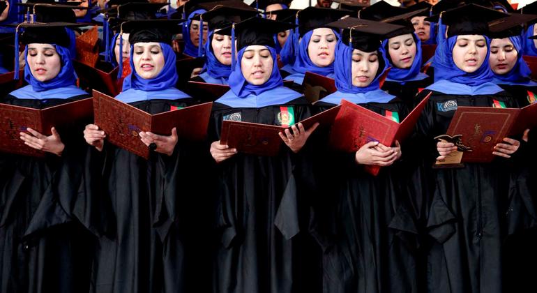 Afghan students stand to perform graduation pledges during their degree-award ceremony at a university in Herat, Afghanistan. 