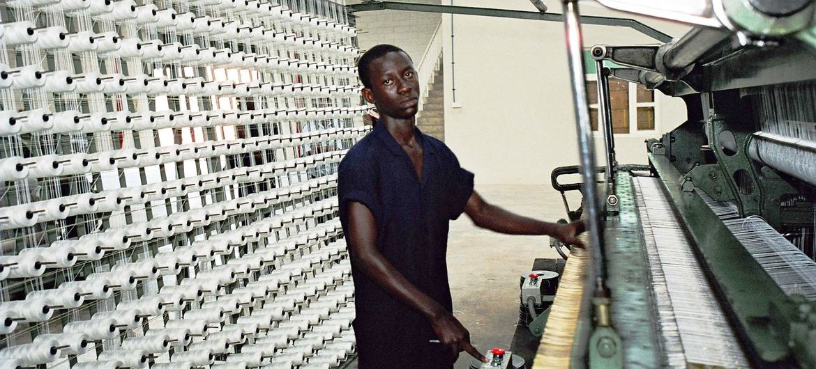 A man works in a factory in Dar Es Saalam.