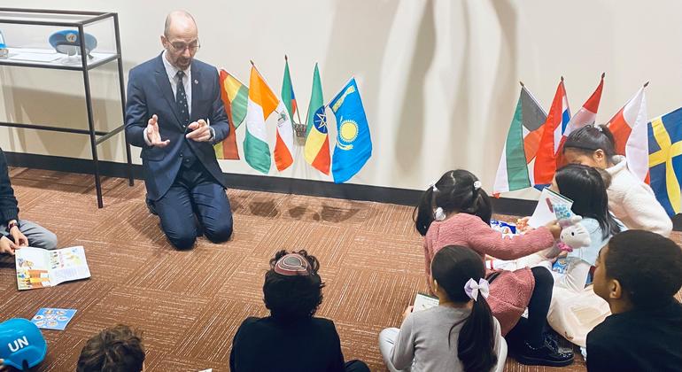 UN Tour Guide Jonathan Mishal explains the UN to a group of young children.