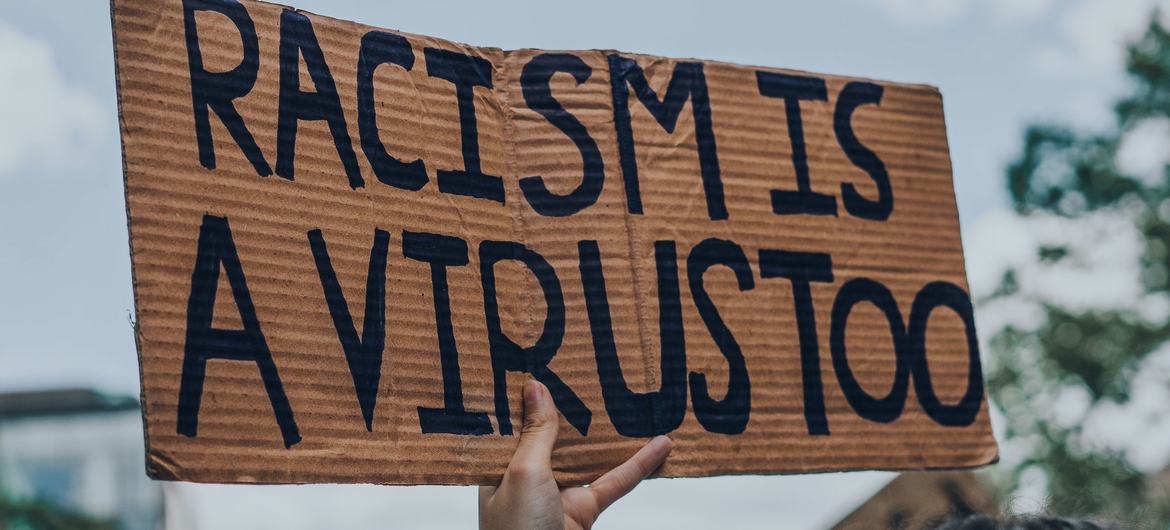 Racism is a Virus sign at a Black Lives Matter protest in Montreal, Canada.