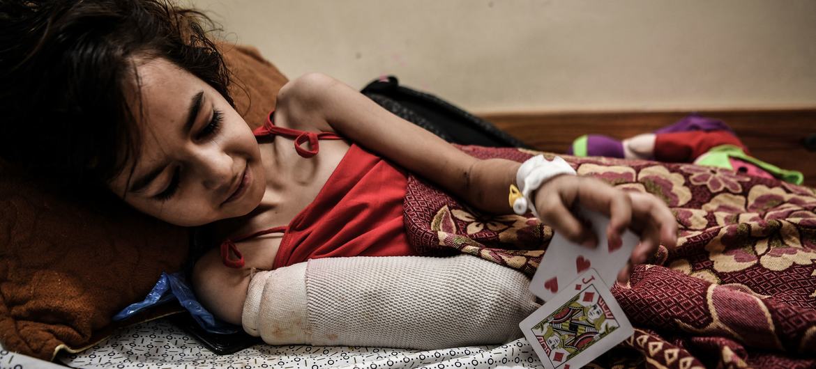 A young girl from Gaza City recovers from the amputation of part of her arm following a missile strike on her home.