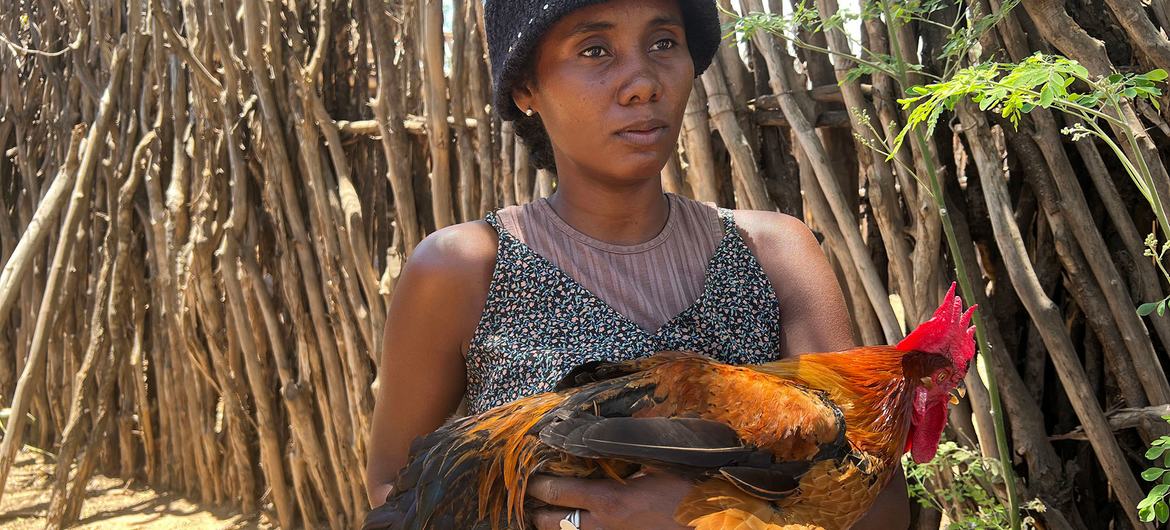 Lucette Vognentseva holds one of the chickens bred from a Tanzanian egg.