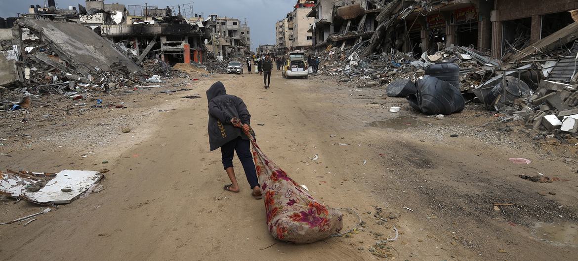 A person drags possessions through the streets of Khan Younis in the south of the Gaza Strip.